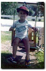A very young Lauren in a swing
