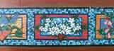 The centre panels of the mosaic by Kate Millington on the building corner.