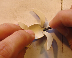 Sanding with a rolled piece of sandpaper.