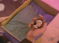 LaCroix opens the box containing Hamid's head