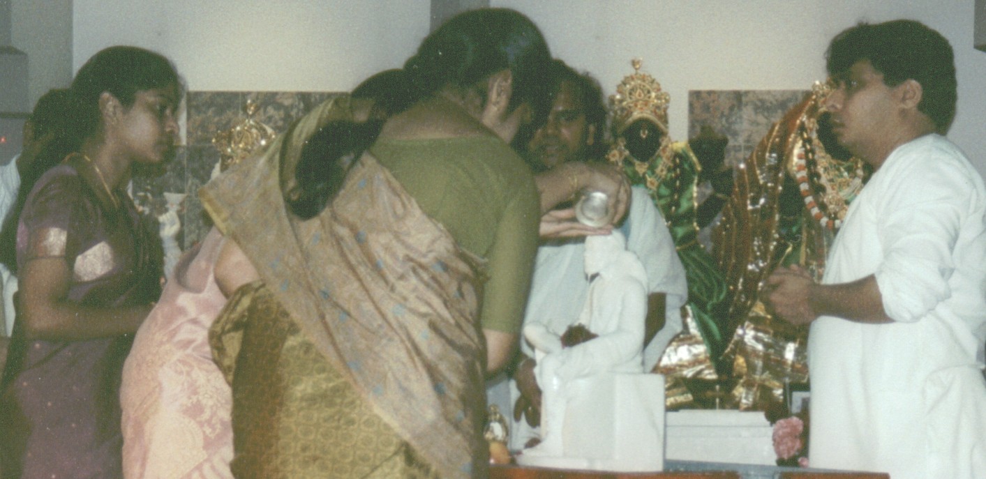 Abhishek being performed to Saibaba's Murti by participating devotees