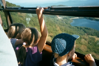 Kids looking out the Tram to Cannon Mountain, Echo Lake below
