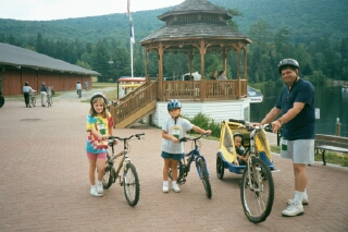 Paul and kids with the bikes by the bandstand