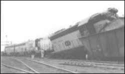 train wreck with a diesel locomative run up on boxcars