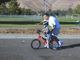 Childhood milestones. Learning to ride bike.