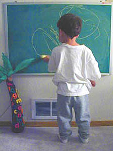 Drawing on his chalkboard.[18,216 bytes]