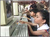 School children in Beijing surf the Internet- AP