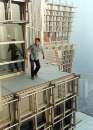An unidentified Chinese man surveys the view from one of the world's tallest buildings, in Shanghai February 18, 2001. The man, who took about an hour to climb the 88-story Jinmao Building without using any equipment, was arrested by police after sucessfully reaching the top of the building. REUTERS/China Photo 