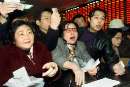 Chinese investors open accounts to trade hard currency B shares at a brokerage in Shanghai, the mainland's financial centre February 28, 2001. China's B shares shot up to near their maximum limit in the first hour of trade after the formerly foreigner-reserved market officially opened to domestic punters on Wednesday. REUTERS/China Photo