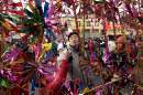 A Chinese man examines pinwheels, a traditional Chinese toy, at a temple fair in central Beijing January 25, 2001. Temple fairs are regular events for Beijing residents to celebrate the annual Spring Festival. -Reuters/Guang Niu