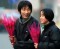 Chinese youths share a light moment as they stroll along a quiet street in Beijing with their roses during Valentine's Day February 14, 2002. Chinese are becoming increasingly open to western festivals after more than two decades of economic reforms. [Reuters] 