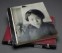 Portraits album from the Hedda Morrison photograph collection showing cover photograph and side-sewn binding on top of closed portfolio-style case with two ivory fasteners. -Harvard-Yenching Library