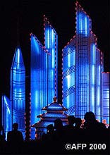 People admire a lighting display showing a modern skyline in Beijing.
