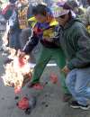 Tibetan demonstrators burn a Chinese flag in New Delhi on January 13, 2001. The Tibetan people accuse the Chinese government of the dilution of their identity, religion and culture since the invasion of Tibet by China in 1949. REUTERS/Kamal Kishore 