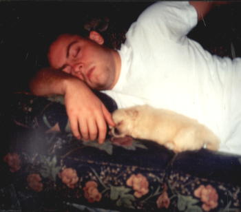 Dwayne sleeping with Wendy's puppy on the sofa