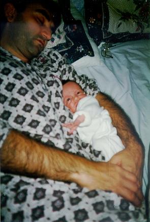 Dad asleep with Nathan resting on his shoulder