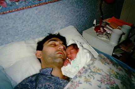 Dad and Nathan asleep together, cheek to cheek
