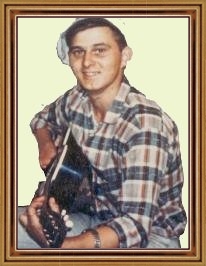 Photo of Kenneth Kvasnikoff playing the guitar.