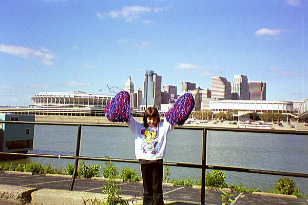 Meagan Covington KY cheering w/Cincinnati Skyline at her back