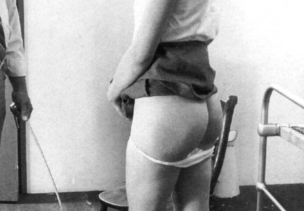 A caning is well beyond my limits. But I like this picture because it's the most basic syntax of a scene, for me: the stern punisher, slightly remote, and the abject punished one, waiting and exposed (picture lifted and re-cropped from Bernie's Spanking Pages)