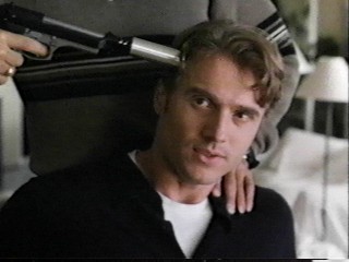 Eric holding gun on Natale