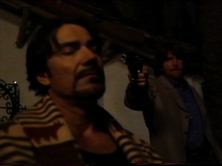 Eric holds a gun