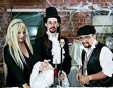 Dr. Fear giving the local indoor football team's rival team a curse in front of 3,650 people with his lab assistant (and wife) 'Trinka'