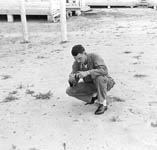 Picture of student squatting to load film in camera