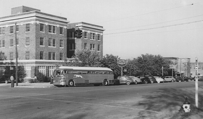 A Greyhound Bus parked at the terminal in the Parker Hotel.