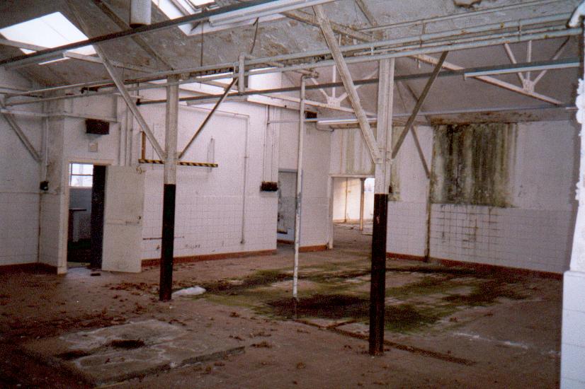(c.1996) internal photo of the stores and admin building, probably laterly used as a canteen and wash area, note tiling on walls, large open spaces, white walls and plenty of light.