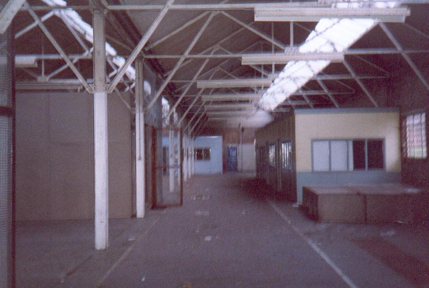 (c.1996) This is a poor image, but shows an area of probably the most used of the four buildings. these rooms shown were offices, store rooms (cage type construction), a bar/mess room also nearby. also in view are the large panel metal shelving units, lying on the floor