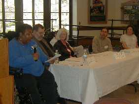 Workshop member Yvette Green reads as poets Dan Maguire, J. C. Todd, Michael Northen and Ther�se Halscheid look on.