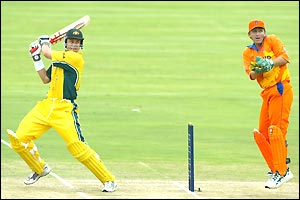 Mengo's Matthew Bukenya hits a shot watched by Jeroen Smit 