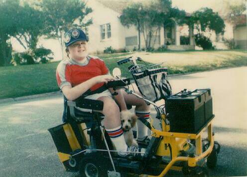 Robbie in motorized vehicle with Doggy