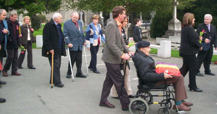 The ceremony moves off from the gates of Glasnevin towards Ryans grave.