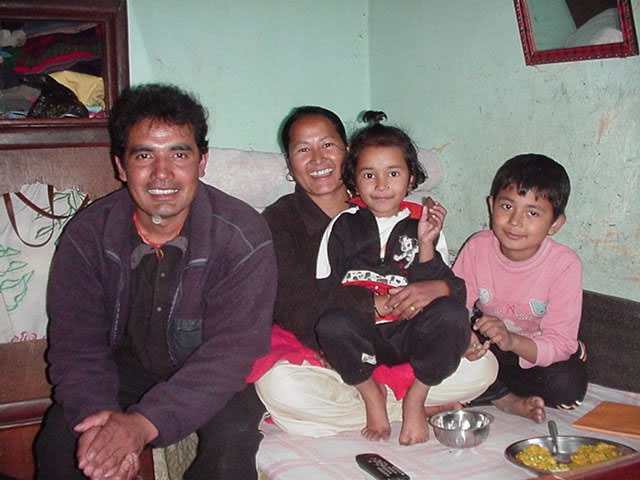 Niru with his two children and his wife.