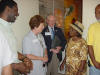 The visitors meet retired school Principal Mrs. Green while the Chairman of the School Board looks on