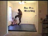 Larry puts a boot across Riley's throat.