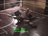 Raeden controls Larry with a headlock.