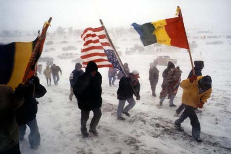Members of Lakota Student Alliance trek toward the Wounded Knee gravesite during the LSA-sponsored 25th Anniversary Event.