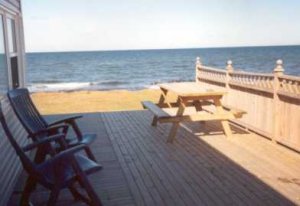 a verandah of a cottage on brackley beach. with chairs!