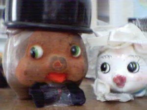 a picture of two piggy banks getting married. not on brackley beach.