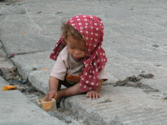 Girl playing on the Swambinath Temple grounds