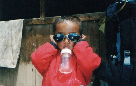 Girl from Upper Pisang enjoying herself with Colin's glasses