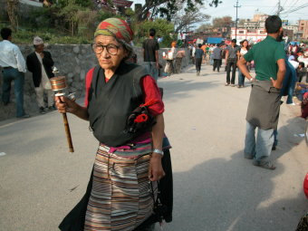 Lady at Swambinath Temple with prayer wheel