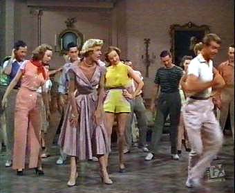 T42, Carol in the pinkish orange costume at the left, Doris Day in the middle and Gene Nelson in full flight