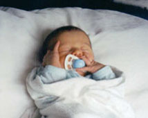 Look at those long fingers! He'll be a pianist like his mom. : )