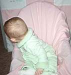 20050311_06b-EmilyGraceHiggins-8mo_greenvelvetoutfit_fromGrandmaBrendaHaroldsen-lookingbehindherchair.jpg