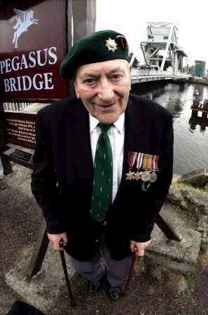Cyril Chew, a veteran of the British Number 3 Commando Unit, standing near Pegasus bridge, which he crossed on D- Day