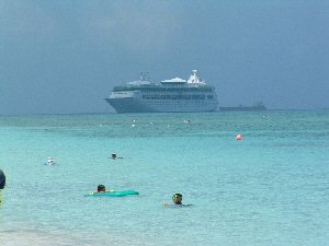 original picture of swimmers with ship in background